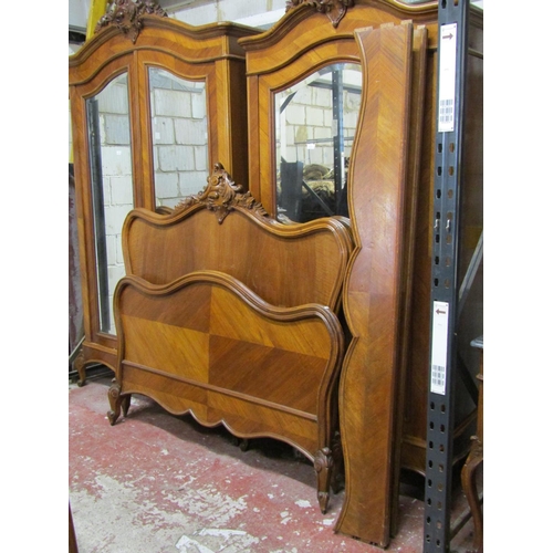 2525 - A walnut veneered double bedstead, the shaped outline with moulded borders set beneath a carved pedi... 