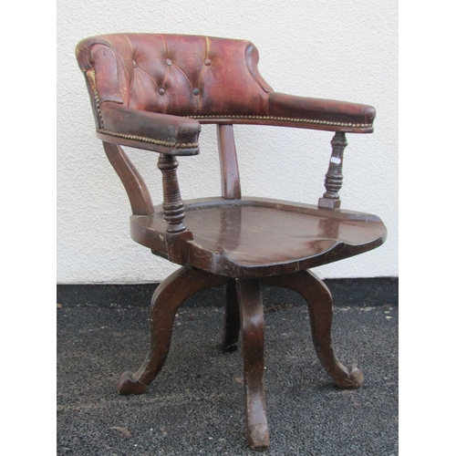 2544 - A late 19th century office chair in mahogany with saddle shaped seat, original tan coloured leather ... 