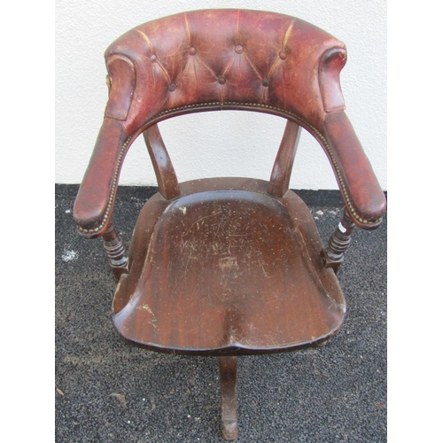 2544 - A late 19th century office chair in mahogany with saddle shaped seat, original tan coloured leather ... 