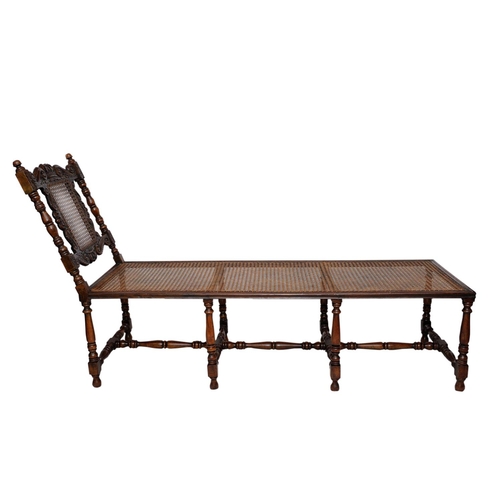 2573 - A carolean day bed in walnut with eight turned supports united by turned rails and stretchers, the b... 