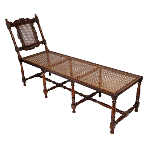 2573 - A carolean day bed in walnut with eight turned supports united by turned rails and stretchers, the b... 