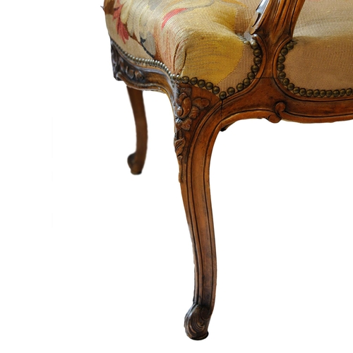 2590 - 19th century French open armchair with carved and moulded showwood frame in beech, with floral tapes... 