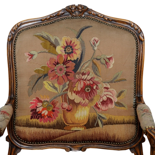 2590 - 19th century French open armchair with carved and moulded showwood frame in beech, with floral tapes... 