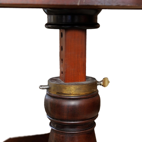 2635 - A Regency mahogany cantilever reading/writing table raised on a turned adjustable column, the top wi... 