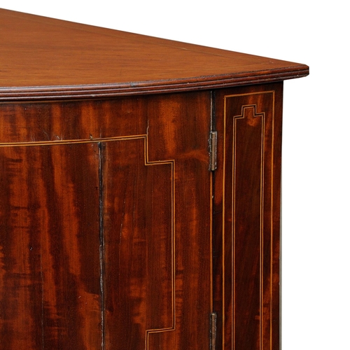 2664 - A Georgian mahogany corner commode with rising lid, with bowfronted outline, the front elevation enc... 