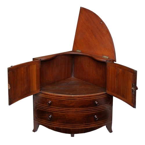 2664 - A Georgian mahogany corner commode with rising lid, with bowfronted outline, the front elevation enc... 