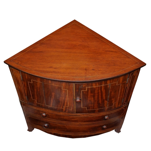 2664 - A Georgian mahogany corner commode with rising lid, with bowfronted outline, the front elevation enc... 