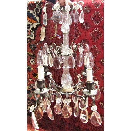 1188 - A three tier wrought iron 19th century style chandelier with four sconces, decorated with large tear... 