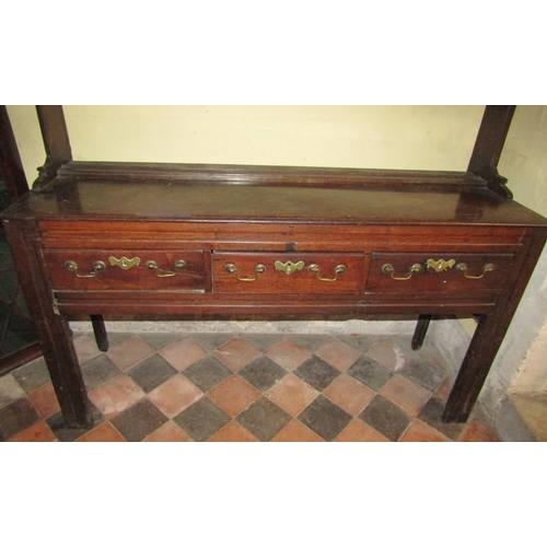 2566 - A small Georgian oak cottage dresser fitted with three frieze drawers and moulded supports, with two... 