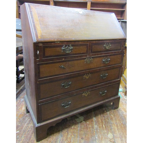 2641 - A Georgian oak bureau of three long and two short drawers, with fitted interior, with crossbanded fi... 