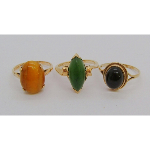 1346 - Three gold cabochon gem rings; a 10k nephrite example, a 9ct tigers eye example and a 9ct quartz exa... 