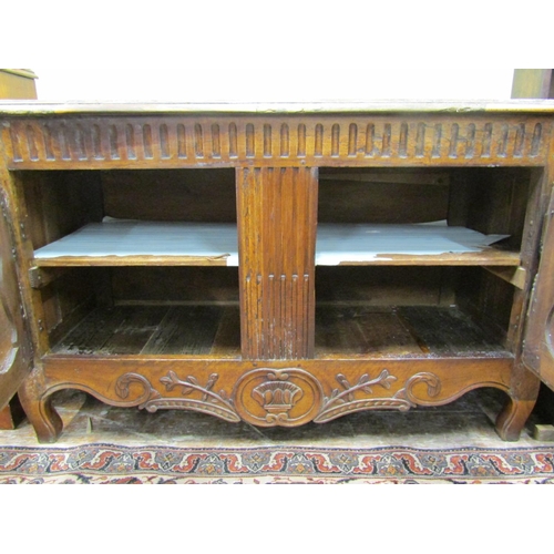 2646 - 18th century continental walnut buffet enclosed by two panelled doors with further carved detail on ... 