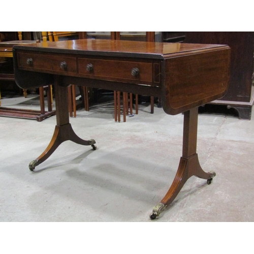 2663 - A Regency mahogany sofa table of usual form enclosing two real and two dummy drawers, on a simple st... 