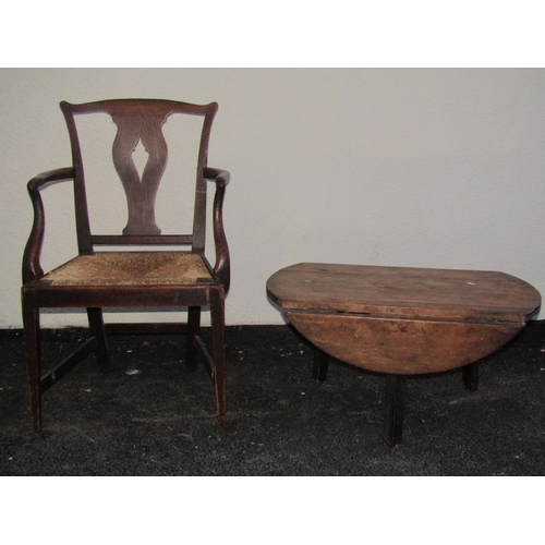 2549 - A Georgian oak countrymade elbow chair with shaped and pierced splat, rush seat and square taper sup... 