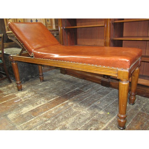 2669 - A Victorian mahogany psychiatrists or examination couch with adjustable headrest, raised on four tur... 