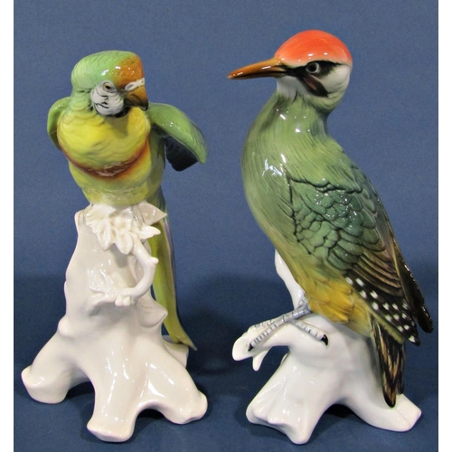 1041 - Two German porcelain figures of a green woodpecker and a parrot, together with a further Portuguese ... 