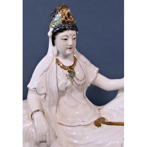 1059 - A Porcelain figure of a seated female with gilded and jade colour highlights