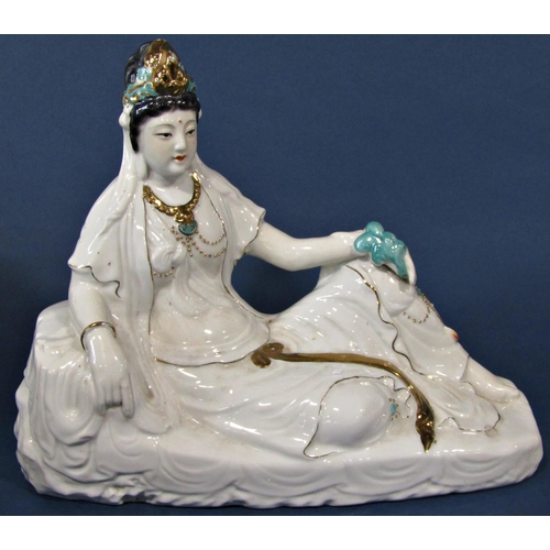 1059 - A Porcelain figure of a seated female with gilded and jade colour highlights