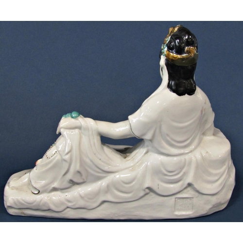 1059 - A Porcelain figure of a seated female with gilded and jade colour highlights