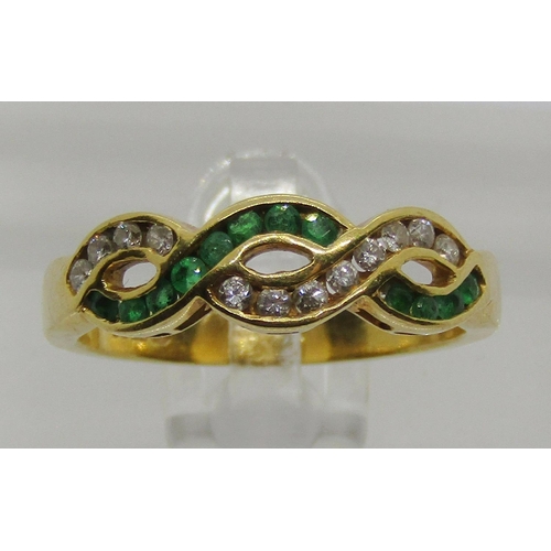 1307 - 18ct channel set emerald and diamond twist ring, size M/N, 3.5g