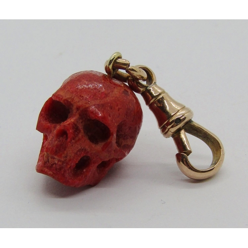 1310 - Carved coral skull fob with attached 9ct dog clip, 4.5g