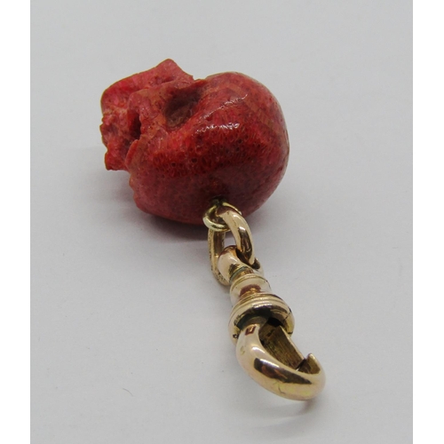 1310 - Carved coral skull fob with attached 9ct dog clip, 4.5g