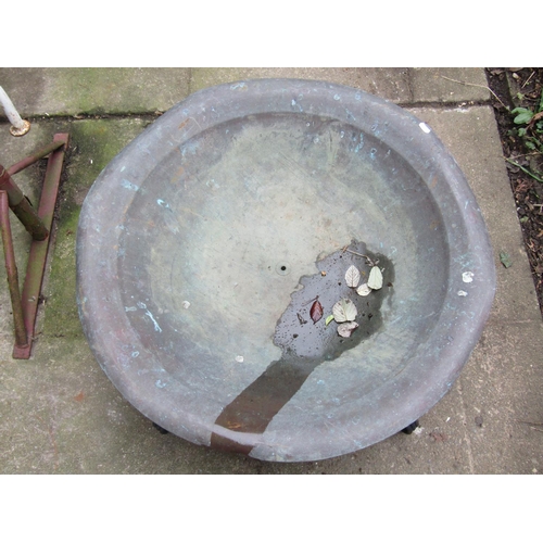 2019 - A fire pit the weathered shallow circular copper bowl set in a low iron work stand with scrolled sup... 