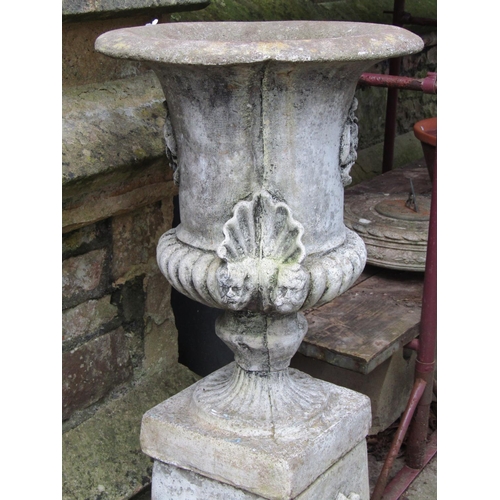 2027 - A painted and weathered cast composition stone garden urn with flared rim and partially lobed body w... 