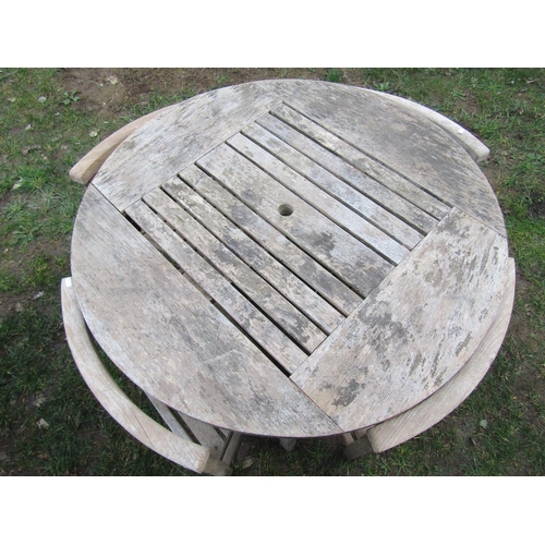 2053 - A Jonelle weathered Burma teak circular garden table with slatted top, approximately one metre in di... 