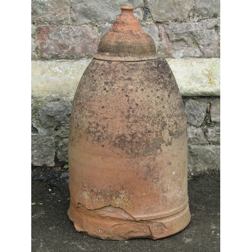 2058 - A weathered terracotta bell shaped rhubarb forcer and domed cap, 65 cm high (af)