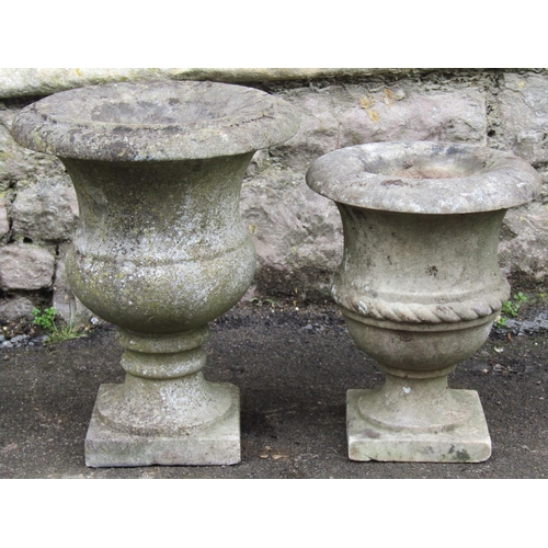 2063 - A small weathered marble urn with flared rim and square cut platform base 30 cm diameter x 38 cm hig... 