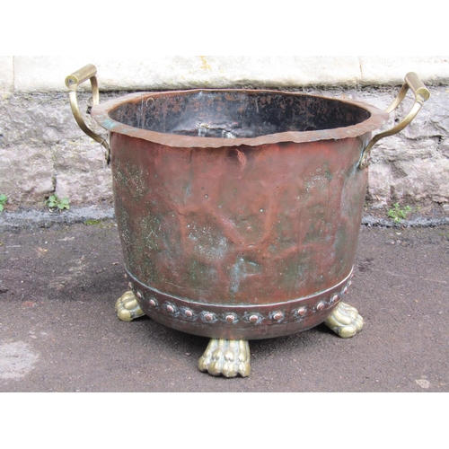 2064 - An antique copper cauldron/log bin with flared rim, pop riveted seams and later brass handles set on... 