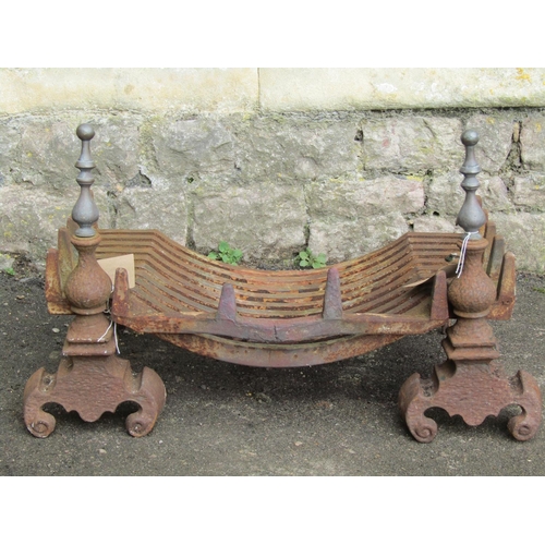 2065 - A cast iron fire grate and loose dogs with brass finials and scrolled supports, together with a furt... 