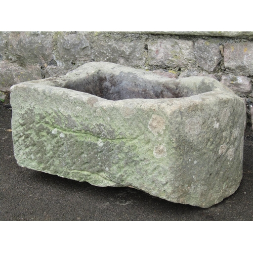 2078 - A weathered thick walled rectangular natural stone trough with single D end 57 cm long x 38 cm wide ... 