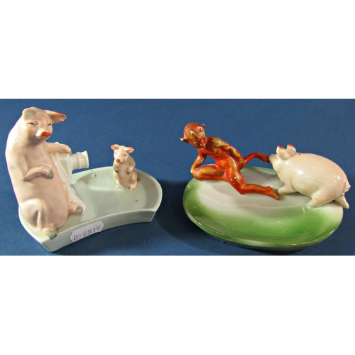 1068 - A group of four late 19th century German figures of pigs in different poses, to include a pig biting... 