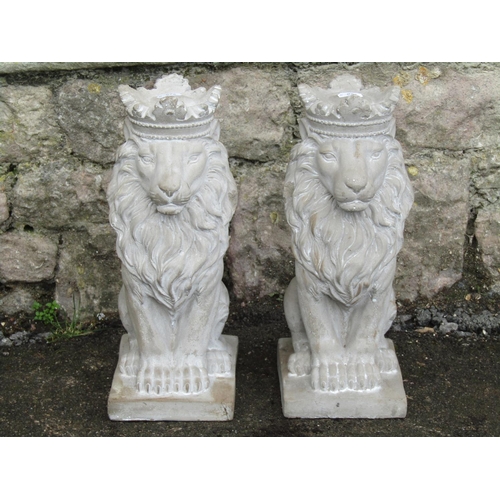 2069 - A pair of small cast composition stone garden/pier ornaments in the form of seated regal lions, 35 c... 