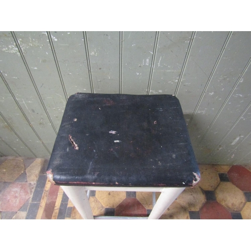 2079 - A vintage painted aluminium industrial stool with rectangular rexine/oil cloth upholstered seat rais... 