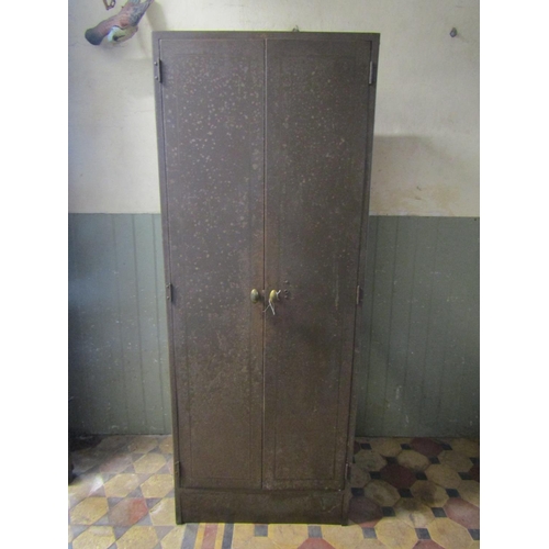 2082 - A vintage industrial steel floorstanding side cabinet enclosed by a pair of full length rectangular ... 