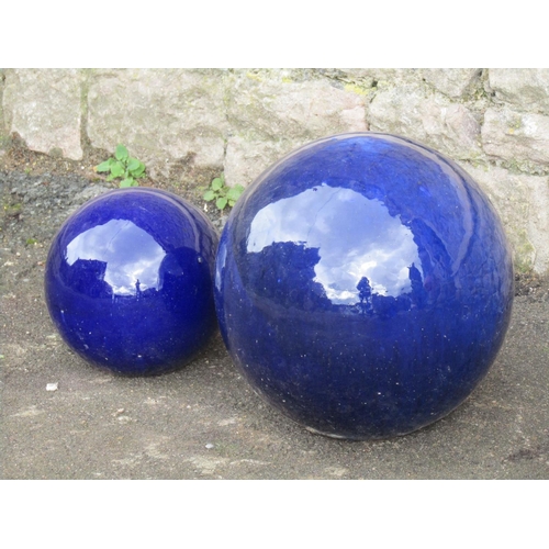 2087 - Two contemporary blue glazed spherical garden ornaments 30cm and 20 cm diameter approximately