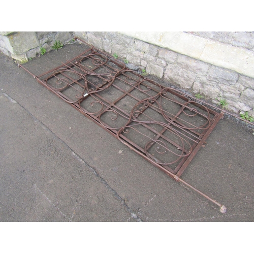 2089 - An antique folding steel bed with decorative scrollwork detail