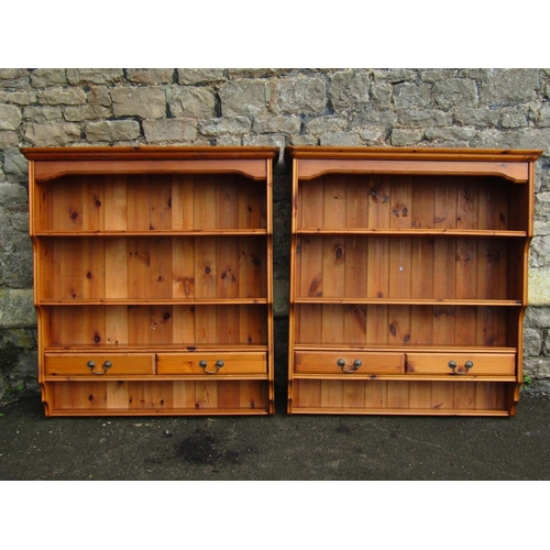 2099 - A pair of contemporary stained pine wall mounted kitchen open plate racks with graduated shelves, th... 