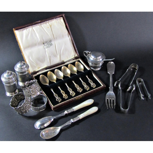 1205 - A mixed selection of silver tableware including a three piece condiment set, three sugar tongs, thre... 