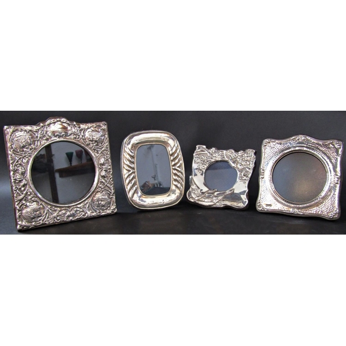 1212 - Three silver photo frames with circular openings, various designs, and a single photo frame with ova... 