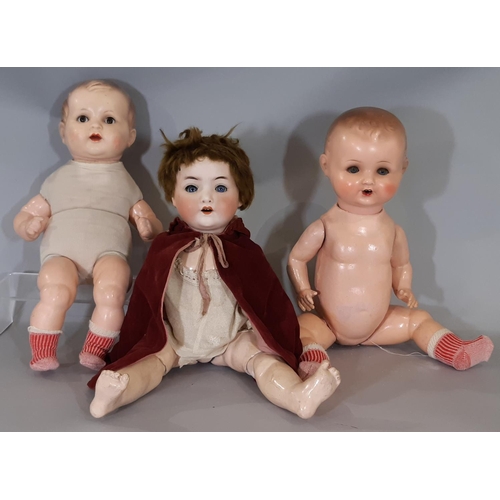 342 - 3 dolls: an early 20th century bisque head German character doll by Ernst Heubach with jointed compo... 