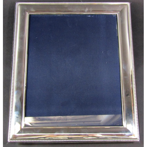 1207 - A silver beaded photo frame, 25 cm x 20 cm opening, frame slightly dented