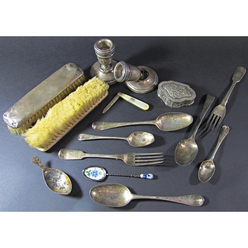 1227 - Seven pieces of silver Georgian flatware, a caddy spoon, a small squat candlestick, three silver bac... 