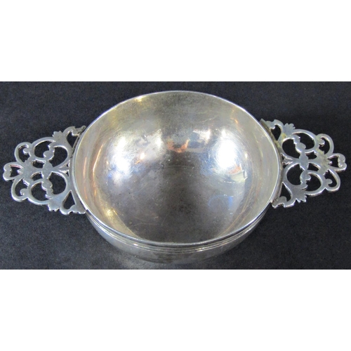 1230 - A silver quaich with double pierced handles, London 1890, maker Wakeley & Wheeler, 14 cm wide, a con... 