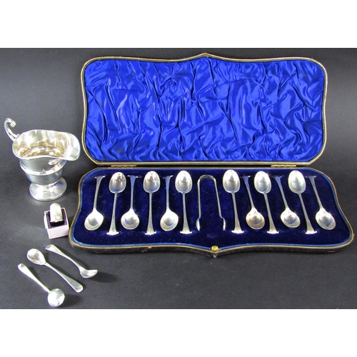 1231 - A cased set of twelve teaspoons and a sugar tong, silver cream jug, three mustard spoons, a thimble,... 