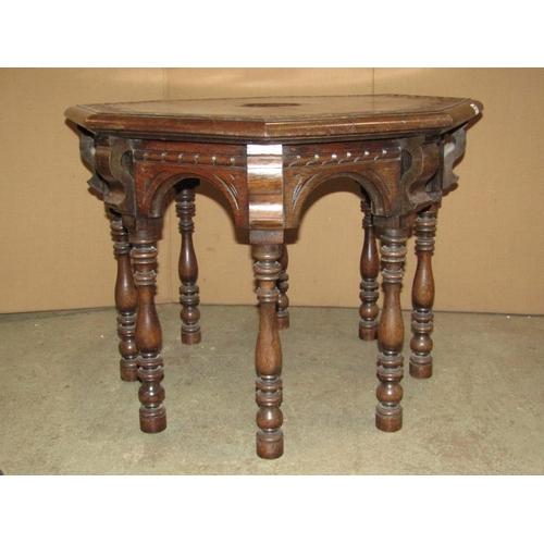 2162 - A Victorian carved oak occasional table of octagonal form with foliate detail raised on turned suppo... 