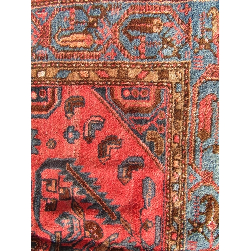 1679 - A North West Persian Zanjan Rug, with a central medallion of stylised flowers on a pink ground,192cm... 